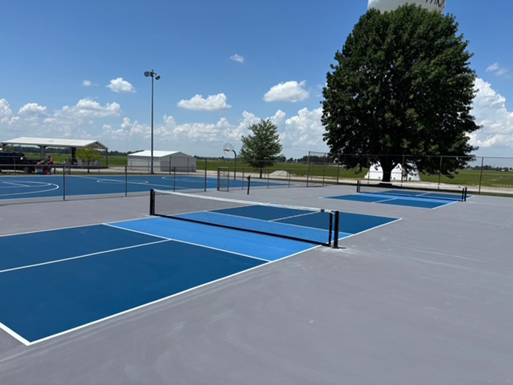 resurfaced multiple blue colored pickle ball court with gray boundaries